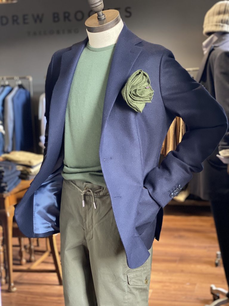 Mens suit with a navy blazer and green top